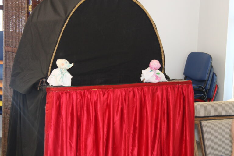Puppet show by two young people using the puppets they made